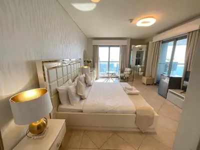 a bedroom with a large bed with a view of the ocean at Stunning Marina View! CoLiving Rooms in Princess Tower Marina in Dubai