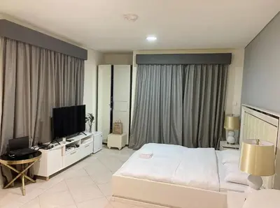 a bedroom with a bed and a flat screen tv at Stunning Marina View! CoLiving Rooms in Princess Tower Marina in Dubai