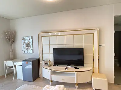 a living room with a television and a table at Stunning Marina View! CoLiving Rooms in Princess Tower Marina in Dubai