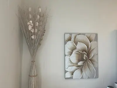 a painting of a flower on a wall next to a vase at Stunning Marina View! CoLiving Rooms in Princess Tower Marina in Dubai