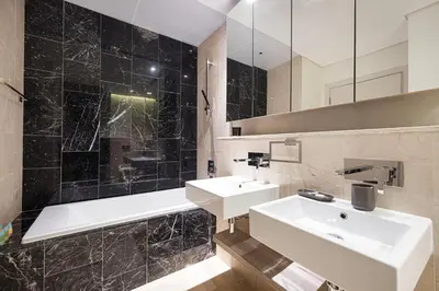 a bathroom with a sink and a tub and a mirror at 2BR with Sea View & Terrace in Dubai