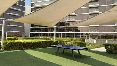 a ping pong table in front of a building at 2BR with Sea View & Terrace in Dubai