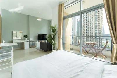 a bedroom with a bed and a large window at HAVN - Studio Unit in Claren Tower, Downtown Dubai in Dubai
