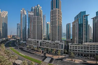a city skyline with tall buildings and palm trees at HAVN - Studio Unit in Claren Tower, Downtown Dubai in Dubai