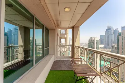 a balcony with a bench and a view of the city at Central 1BR with Downtown Fountain Views in Dubai