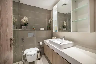 a bathroom with a sink and a toilet and a mirror at Sophisticated 1 Bed Suite in Dubai Marina in Dubai