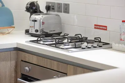 a stove top oven sitting on a counter in a kitchen at Sophisticated 1 Bed Suite in Dubai Marina in Dubai