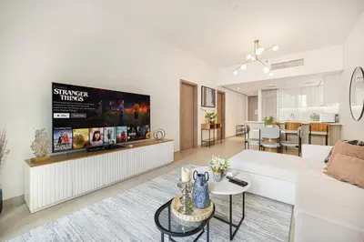 a living room with a white couch and a tv at Sophisticated 1 Bed Suite in Dubai Marina in Dubai