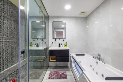 a bathroom with a tub and a sink and a shower at Upgraded 3BR Jacuzzi & Comfort at JBR in Dubai