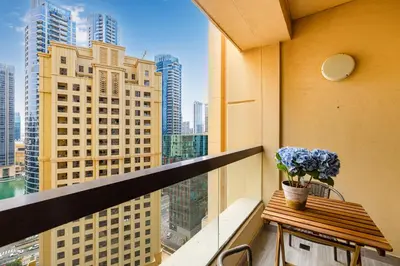 a balcony with a table with a plant on it at Upgraded 3BR Jacuzzi & Comfort at JBR in Dubai
