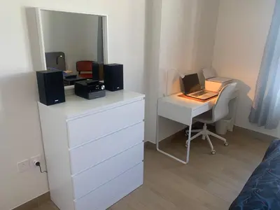 a bedroom with a desk with a computer and a mirror at les voiles in Dubai