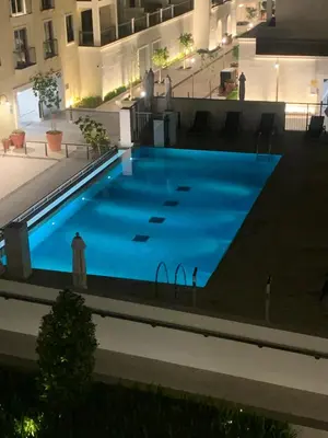 a large blue swimming pool in a building at les voiles in Dubai