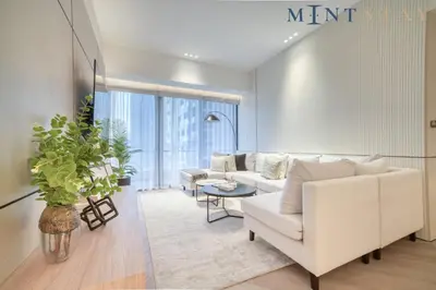a living room with a white couch and a table at Silverene Tower B, Dubai Marina - Mint Stay in Dubai