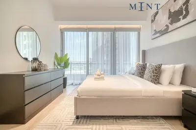 a bedroom with a bed and a dresser and a mirror at Silverene Tower B, Dubai Marina - Mint Stay in Dubai