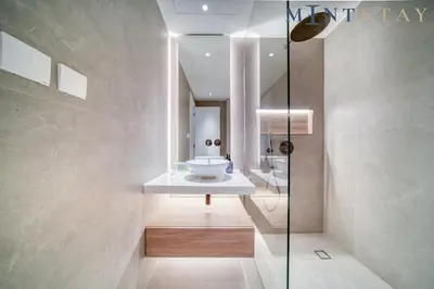 a bathroom with a sink and a mirror at Silverene Tower B, Dubai Marina - Mint Stay in Dubai