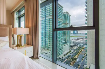 a bedroom with a large window with a view of a city at Privet Beach 2BR in Dubai Marina in Dubai