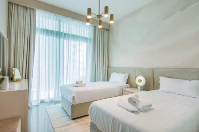 a hotel room with two beds and a window at Privet Beach 2BR in Dubai Marina in Dubai