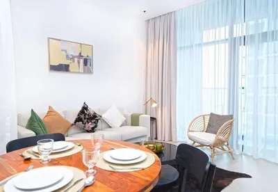 a living room with a table and a couch at EasyGo - Northside Tower 2 Canal View in Dubai