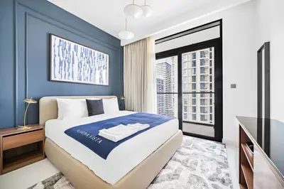 a bedroom with a king sized bed and a television at Silkhaus Sea & Palm View 1BDR at Marina Vista in Dubai