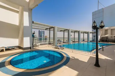 a swimming pool on the roof of a building at HAVN - Studio in Downtown, Near Dubai Mall in Dubai