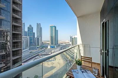a balcony of a building with a view of a city at HAVN - Studio in Downtown, Near Dubai Mall in Dubai
