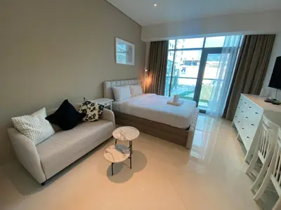 a living room with a couch and a bed at Black and white flower oasis in Seven Palm in Dubai
