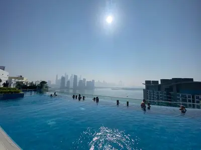 a group of people in a swimming pool in the water at Black and white flower oasis in Seven Palm in Dubai