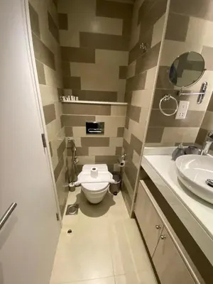 a bathroom with a toilet and a sink at Black and white flower oasis in Seven Palm in Dubai