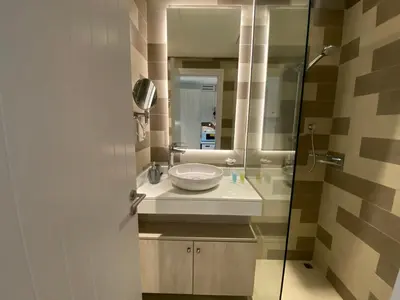 a bathroom with a sink and a mirror at Black and white flower oasis in Seven Palm in Dubai