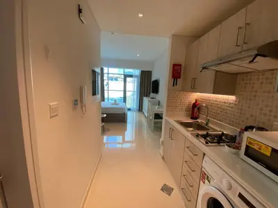 a kitchen with a sink and a stove top oven at Black and white flower oasis in Seven Palm in Dubai