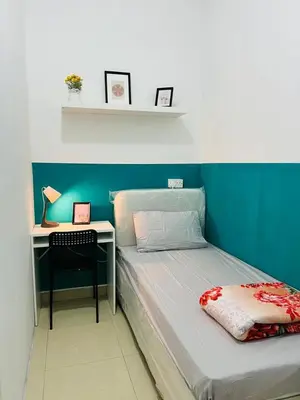 a small bedroom with a bed and a desk at Stop Over Partition Room in Al Barsha 1 Near Mashreq Metro in Dubai