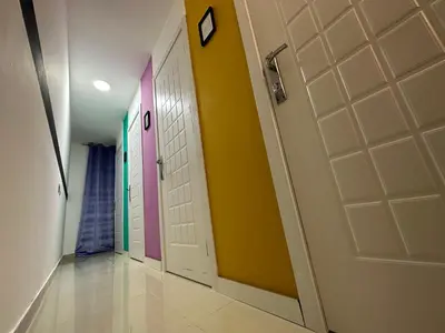 a hallway with doors painted different colors at Partition Room 5 Mins to Mashreq Metro in Dubai