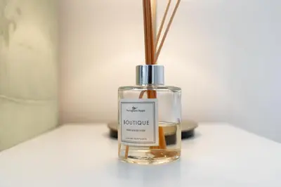 a bottle of perfume sitting on a table at UrbanHomes - Exceptional 2 Bedroom Apt in A Family Friendly Neighborhood in Dubai