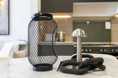 a black vase sitting on a table next to a pair of gloves at UrbanHomes - Exceptional 2 Bedroom Apt in A Family Friendly Neighborhood in Dubai