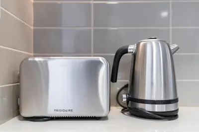 a toaster sitting on a counter in a kitchen at UrbanHomes - Exceptional 2 Bedroom Apt in A Family Friendly Neighborhood in Dubai