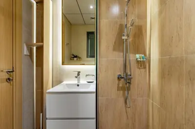 a bathroom with a shower and a sink at GuestReady Holiday Homes - Arabian Elegance in JVC in Dubai