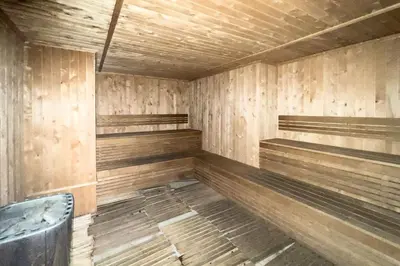 a empty sauna with wooden walls and benches at GuestReady Holiday Homes - Arabian Elegance in JVC in Dubai