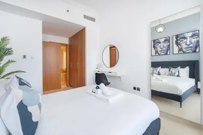 a hotel room with two beds and a mirror at HAVN -1 Bedroom Apartment with Dubai Marina View in Dubai
