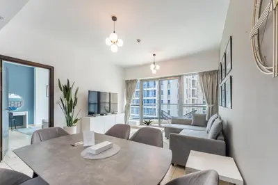 a living room with a table and chairs and a couch at HAVN -1 Bedroom Unit in Dubai Marina, Marina View in Dubai