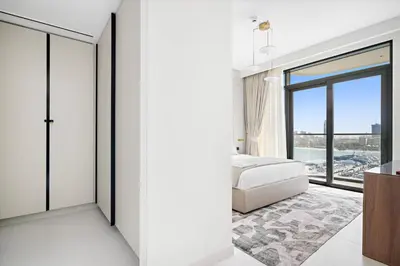 a bedroom with a bed and a large window at Silkhaus Full Marina View 2BDR in Unique New Tower in Dubai