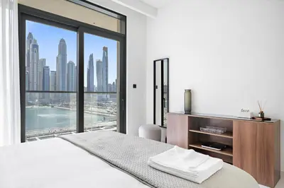a bedroom with a bed and a large window at Silkhaus Full Marina View 2BDR in Unique New Tower in Dubai