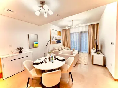 a living room with a table and a couch at Park Heights Deluxe 1bedroom in Dubai