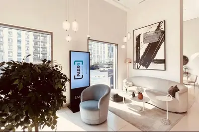 a living room with a couch and a table and a plant at Park Heights Deluxe 1bedroom in Dubai