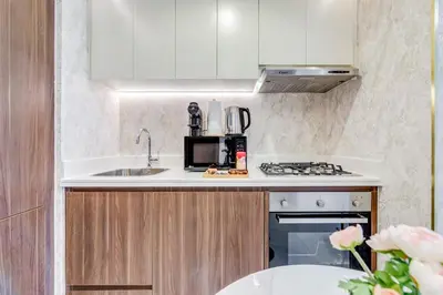a kitchen with a sink and a microwave at GlobalStay Reva & Vera Residences Business Bay Apartments in Dubai