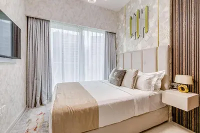a bedroom with a large bed and a window at GlobalStay Reva & Vera Residences Business Bay Apartments in Dubai
