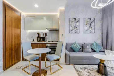 a kitchen and living room with a couch and a table at GlobalStay Reva & Vera Residences Business Bay Apartments in Dubai