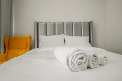 a bed with white towels on top of it at Perfect Studio Apartment Near to Metro Station in Dubai