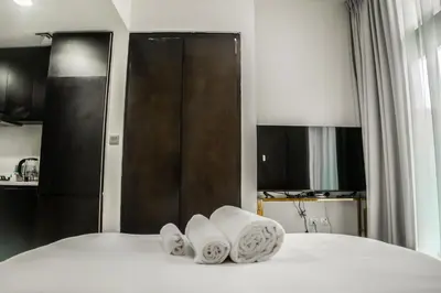 a bedroom with a bed with towels on it at Perfect Studio Apartment Near to Metro Station in Dubai