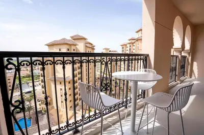 a balcony with a table and chairs and a view at Veluxa - Fantastic 1 Bed - in Jumeirah Golf Estate! in Dubai