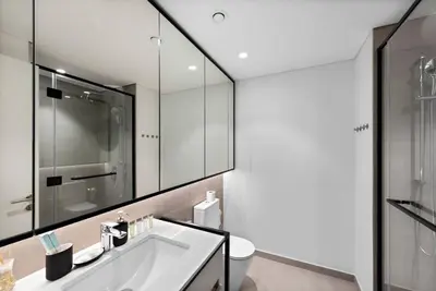 a bathroom with a sink and a mirror at StoneTree - Brand new Studio in Mohammed Bin Rashid City in Dubai
